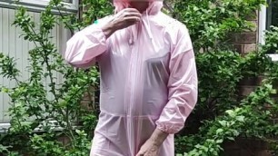 Tranny slut in pink PVC boiler suit outdoors